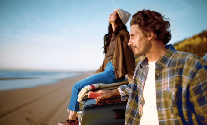 Image of a man & a woman gazing a sunset