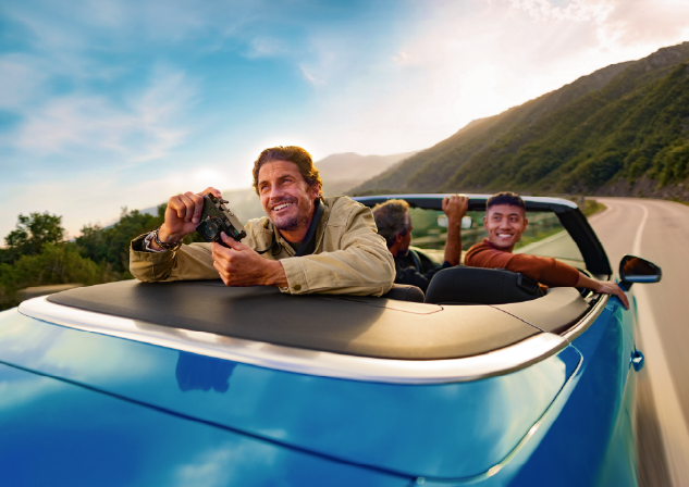 Male riding in a blue car