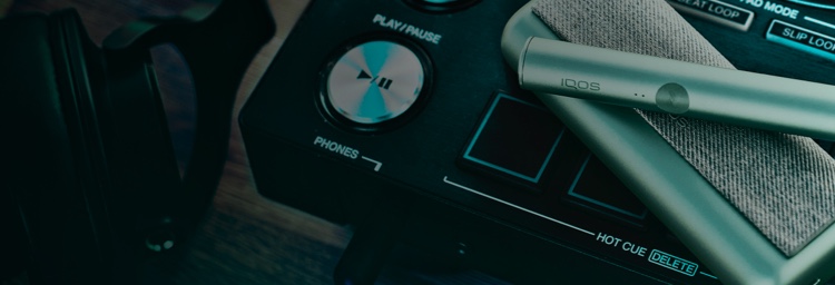 An IQOS device on a sound mixing board.