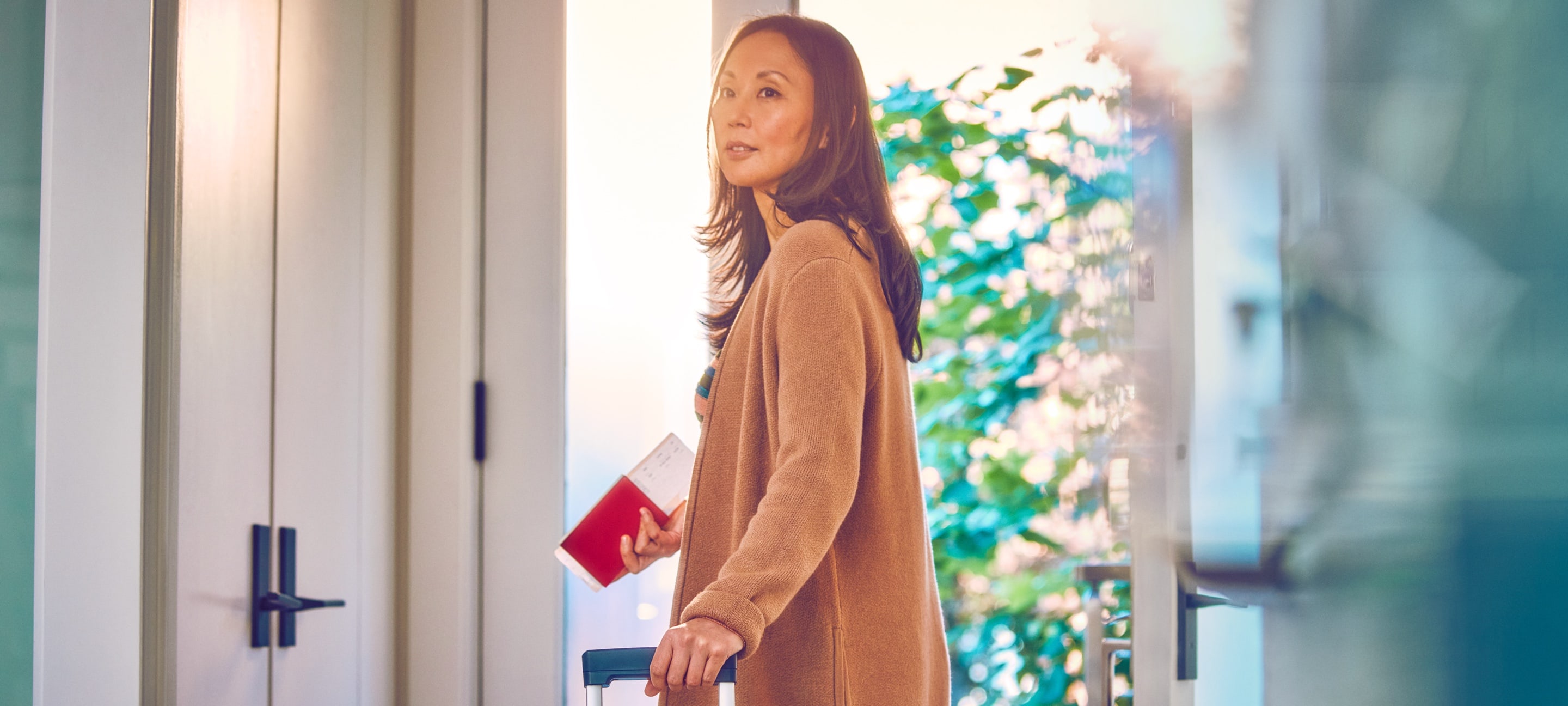 A woman holding travel documents.