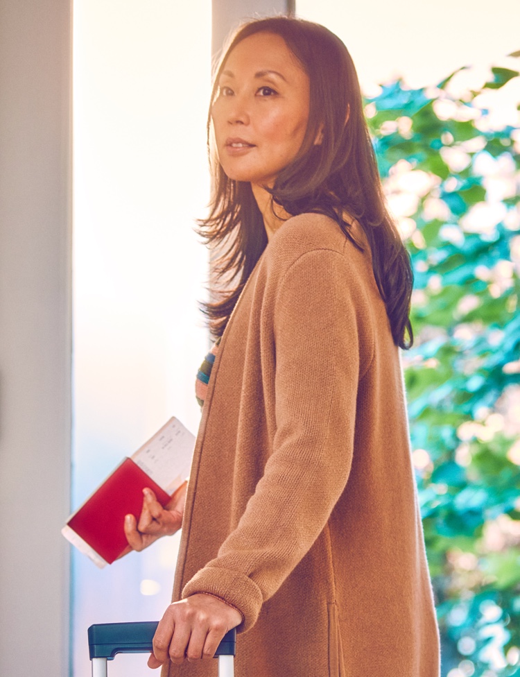 A woman holding travel documents.