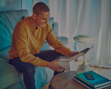 Young man opens his IQOS gift box
