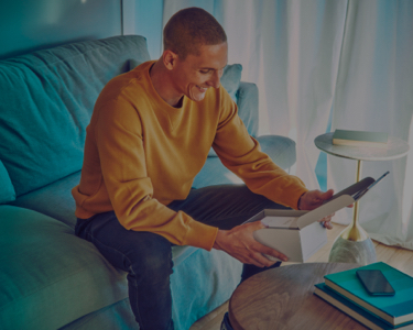 Young man opens his IQOS gift box