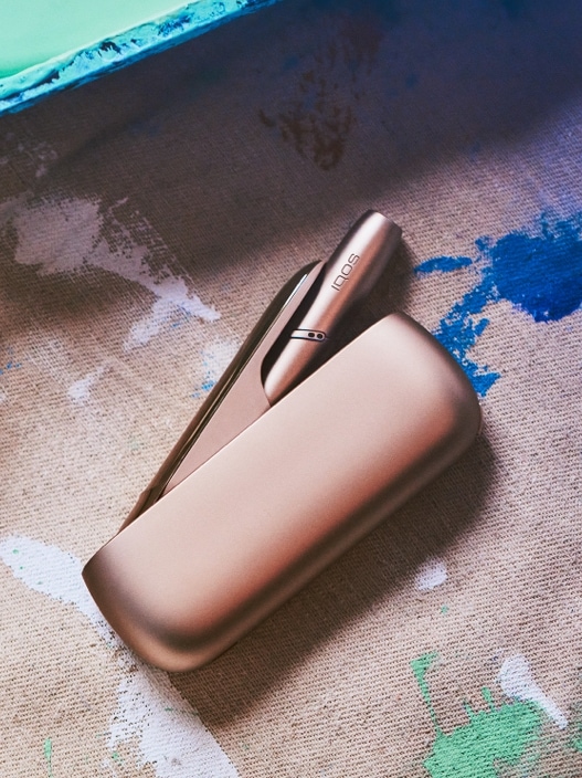 A blue IQOS device and holder.