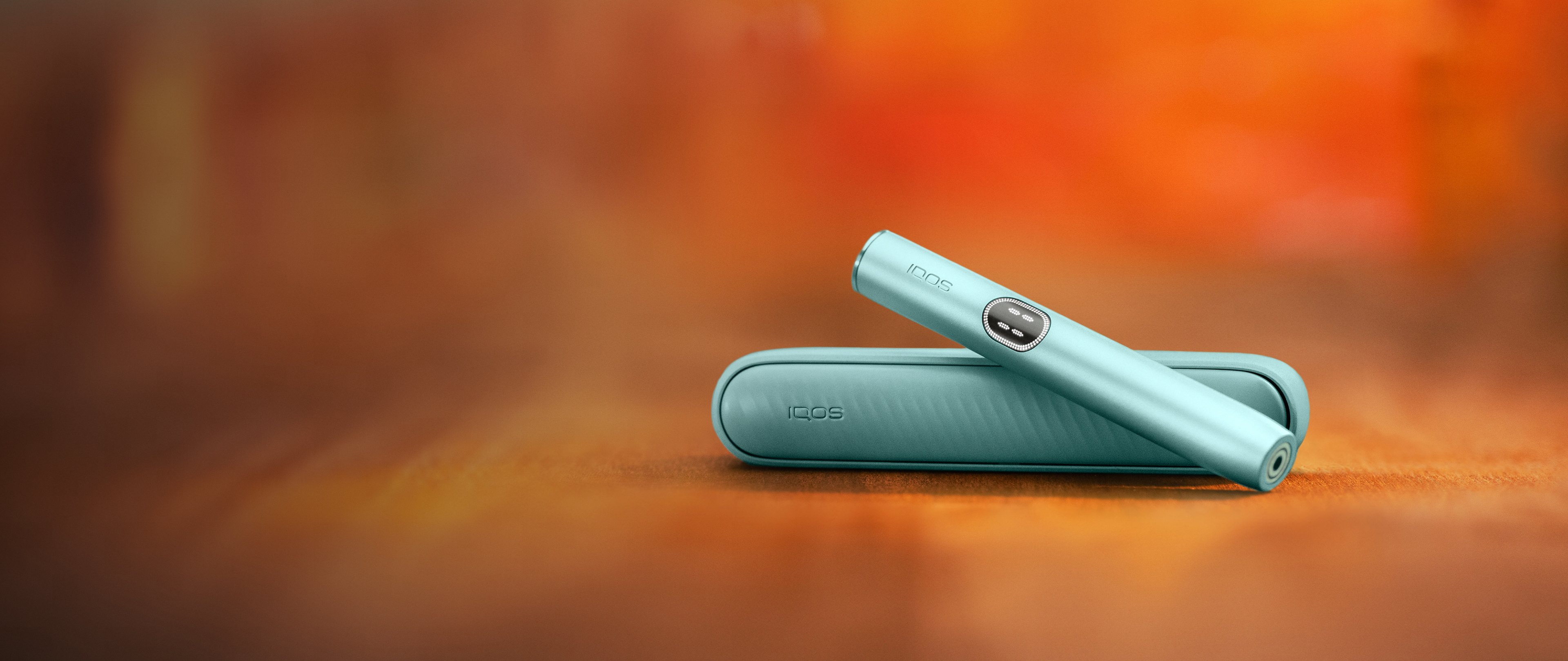 IQOS ILUMA PRIME Breeze Blue placed on a table