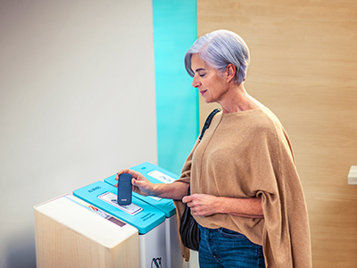 Woman recycling IQOS 2.4+ device