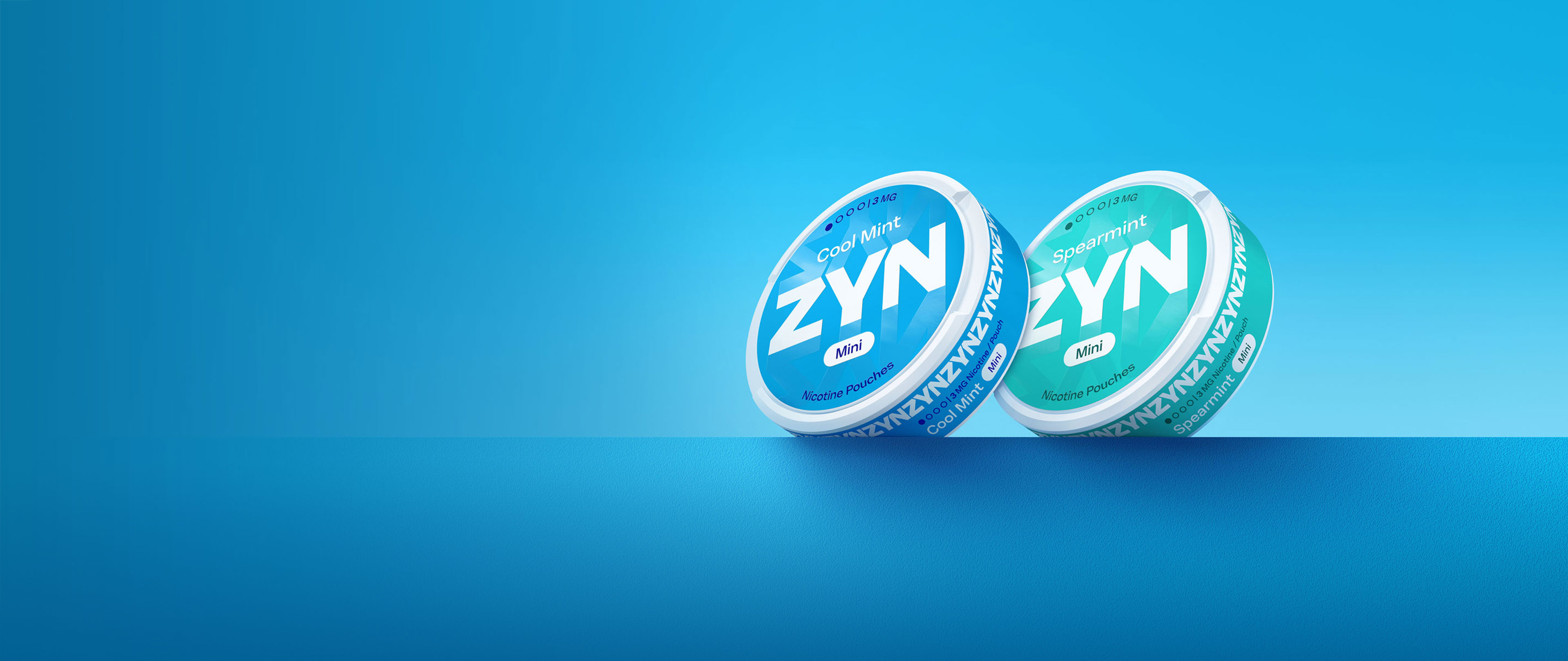 Man in an airplane holding a blue ZYN can in his hand