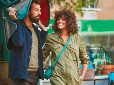 Man and woman outside walking in conversation