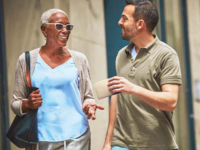 Two people walking in conversation