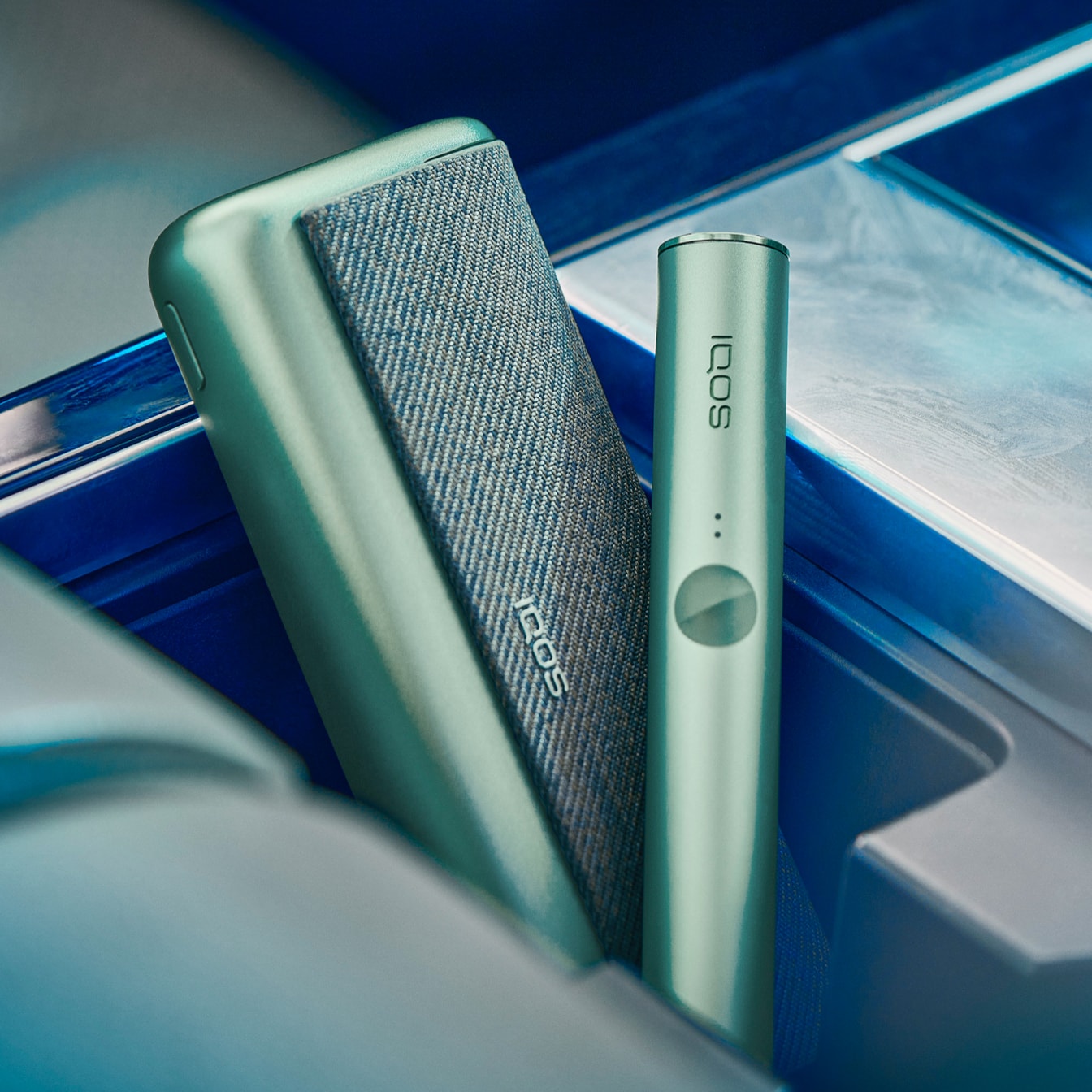 A Jade Green IQOS ILUMA PRIME Pocket Charger and Holder.