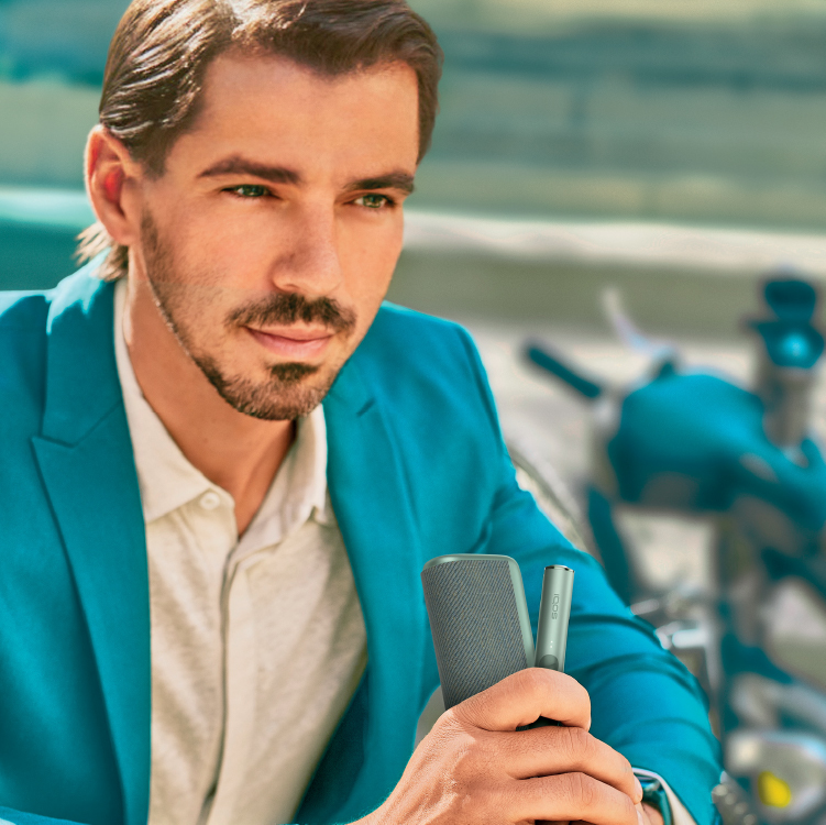 A man using an IQOS device.