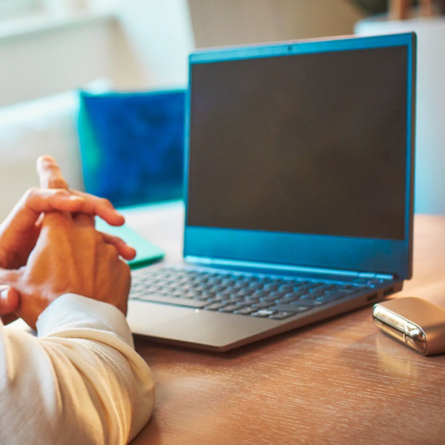 A laptop computer and IQOS device on a table