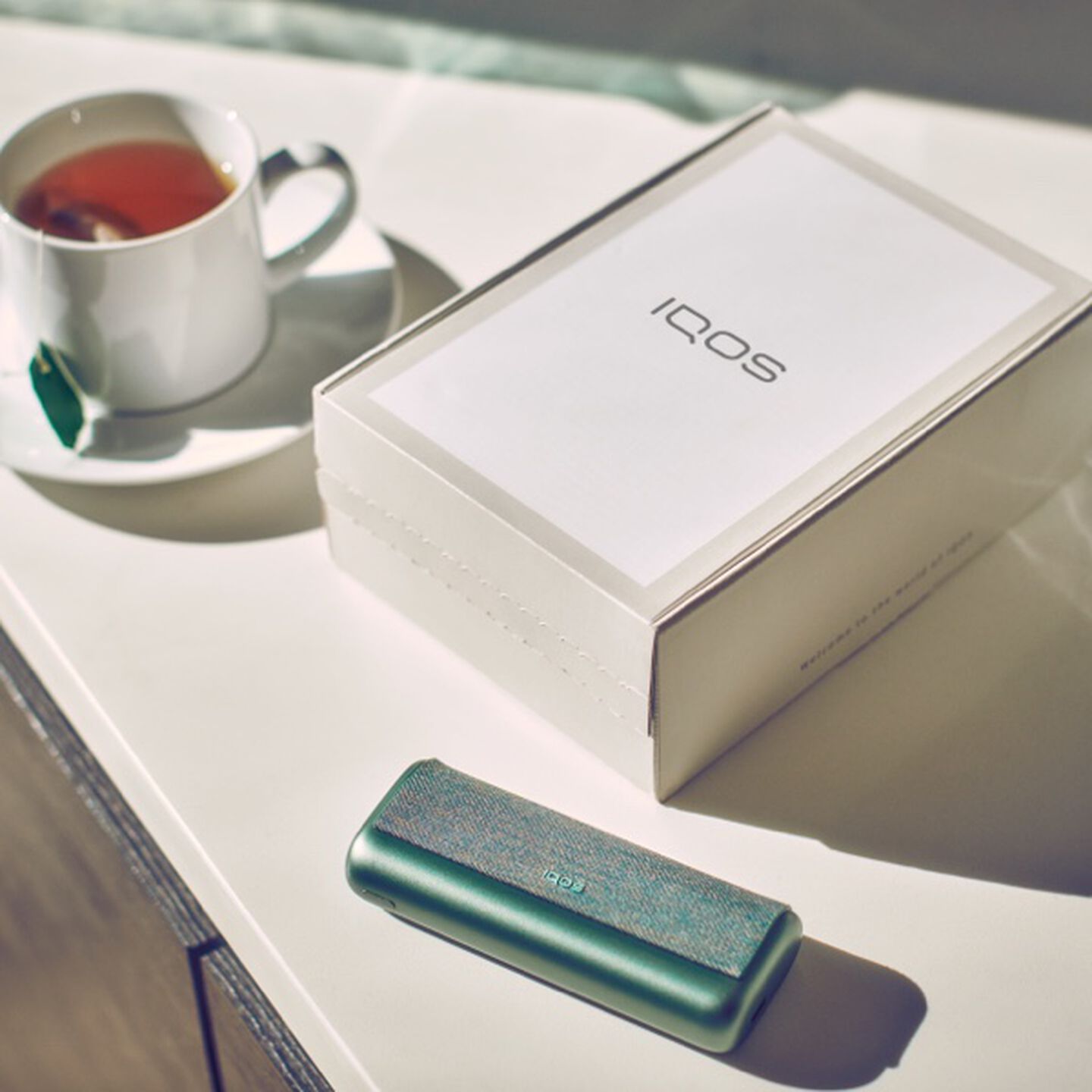 An IQOS box and IQOS ILUMA PRIME on a table