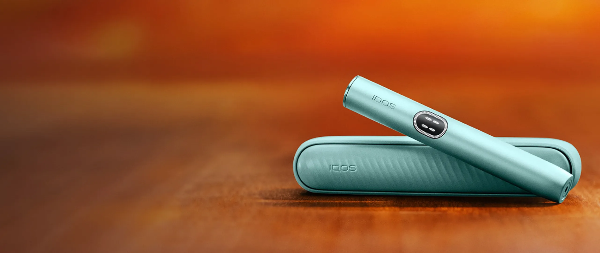 Breeze Blue IQOS ILUMA i device with its charger.