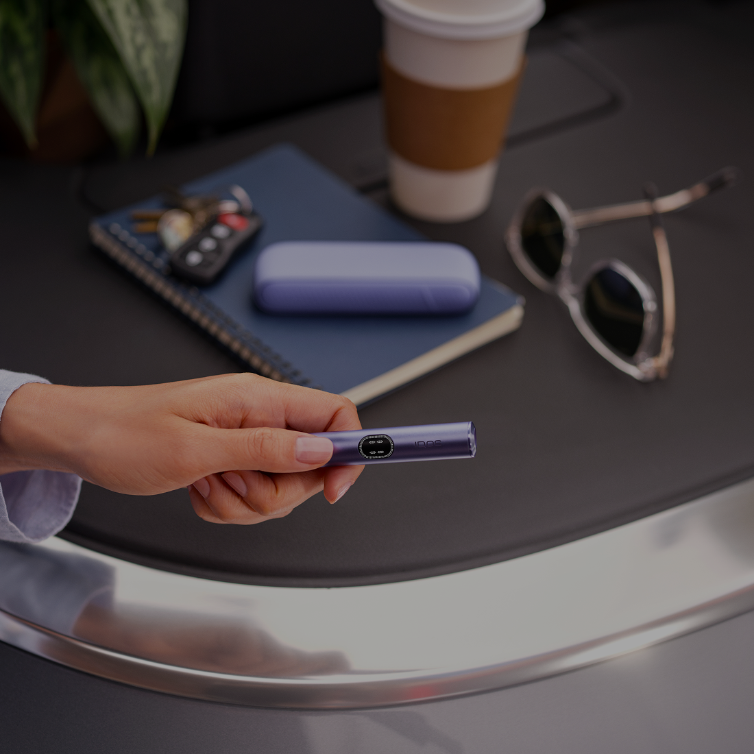 Iluma i azul con cargador texturizado colocado sobre mesa junto a café y llaves