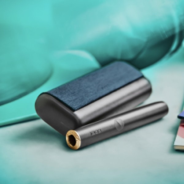 A person places a TEREA stick into an IQOS ILUMA PRIME Holder.