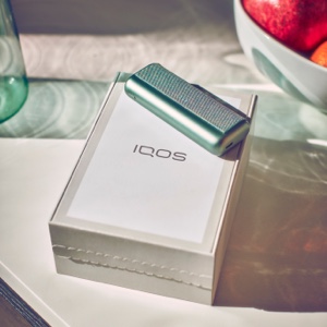 An IQOS box and IQOS ILUMA PRIME Pocket Charger.