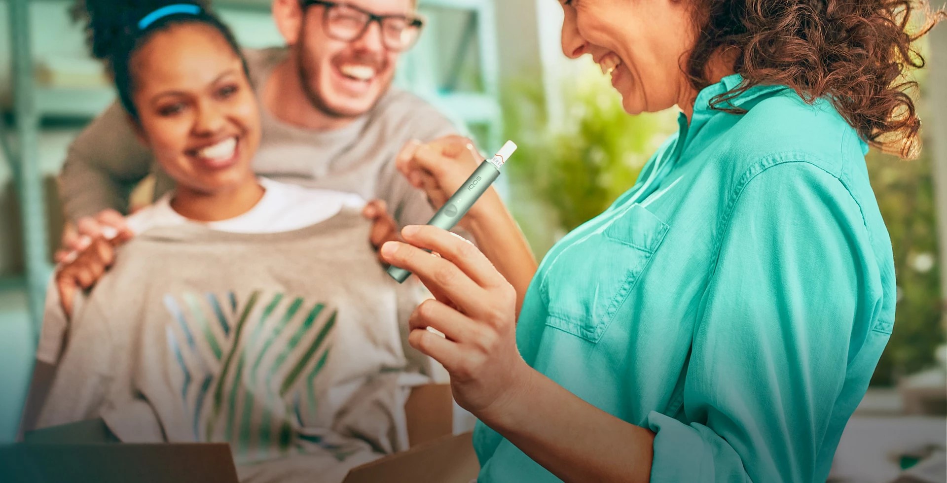 A smiling woman with an IQOS ILUMA device