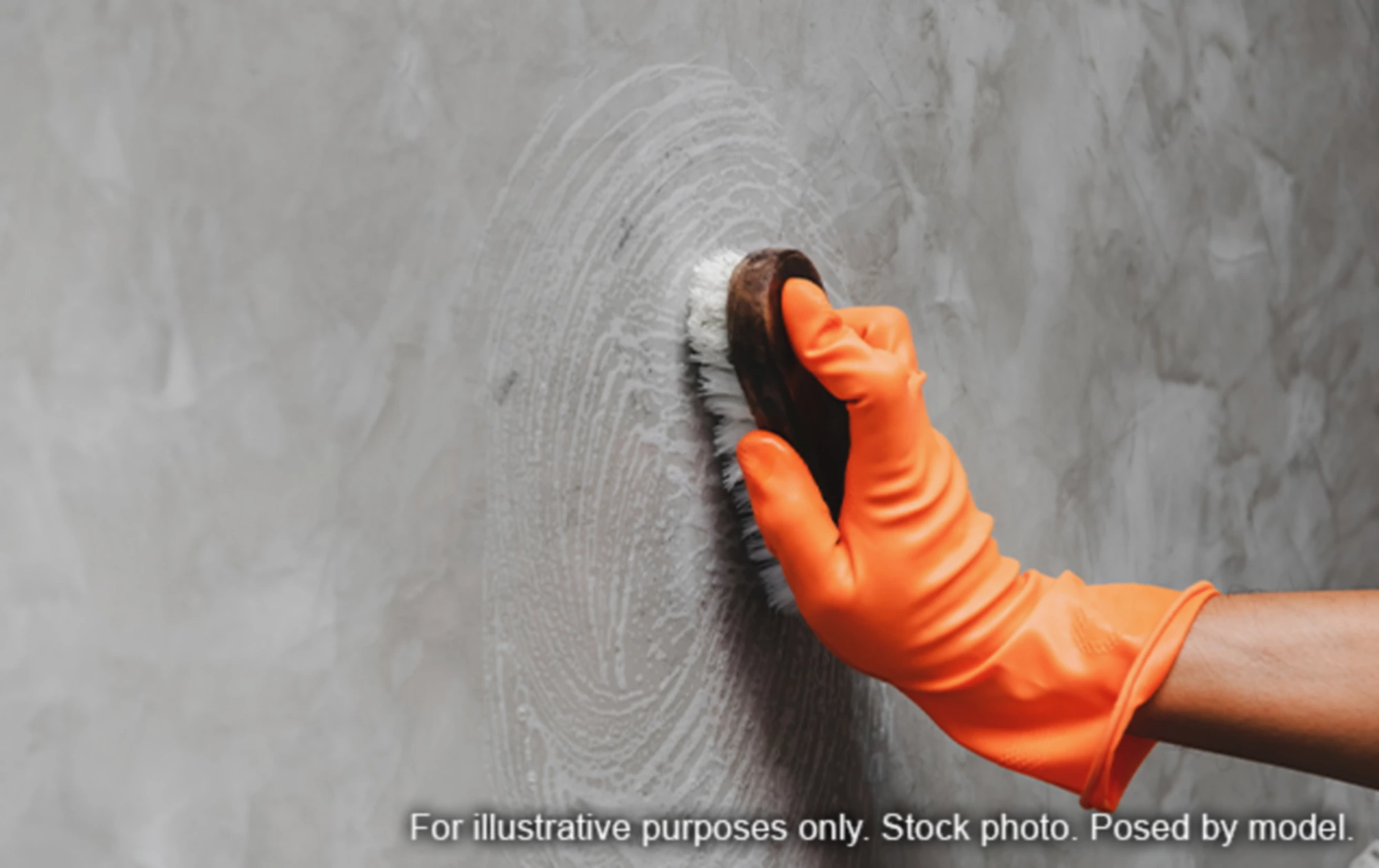 Person cleaning wall