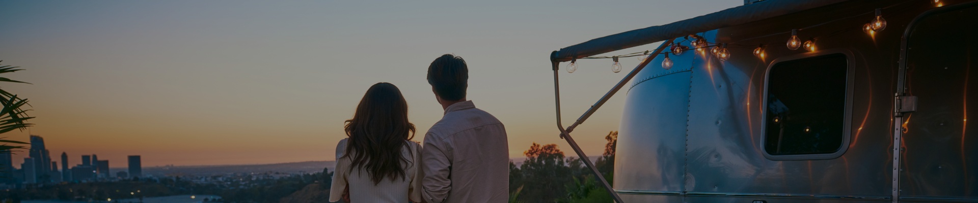 A couple camping together and looking over the horizon