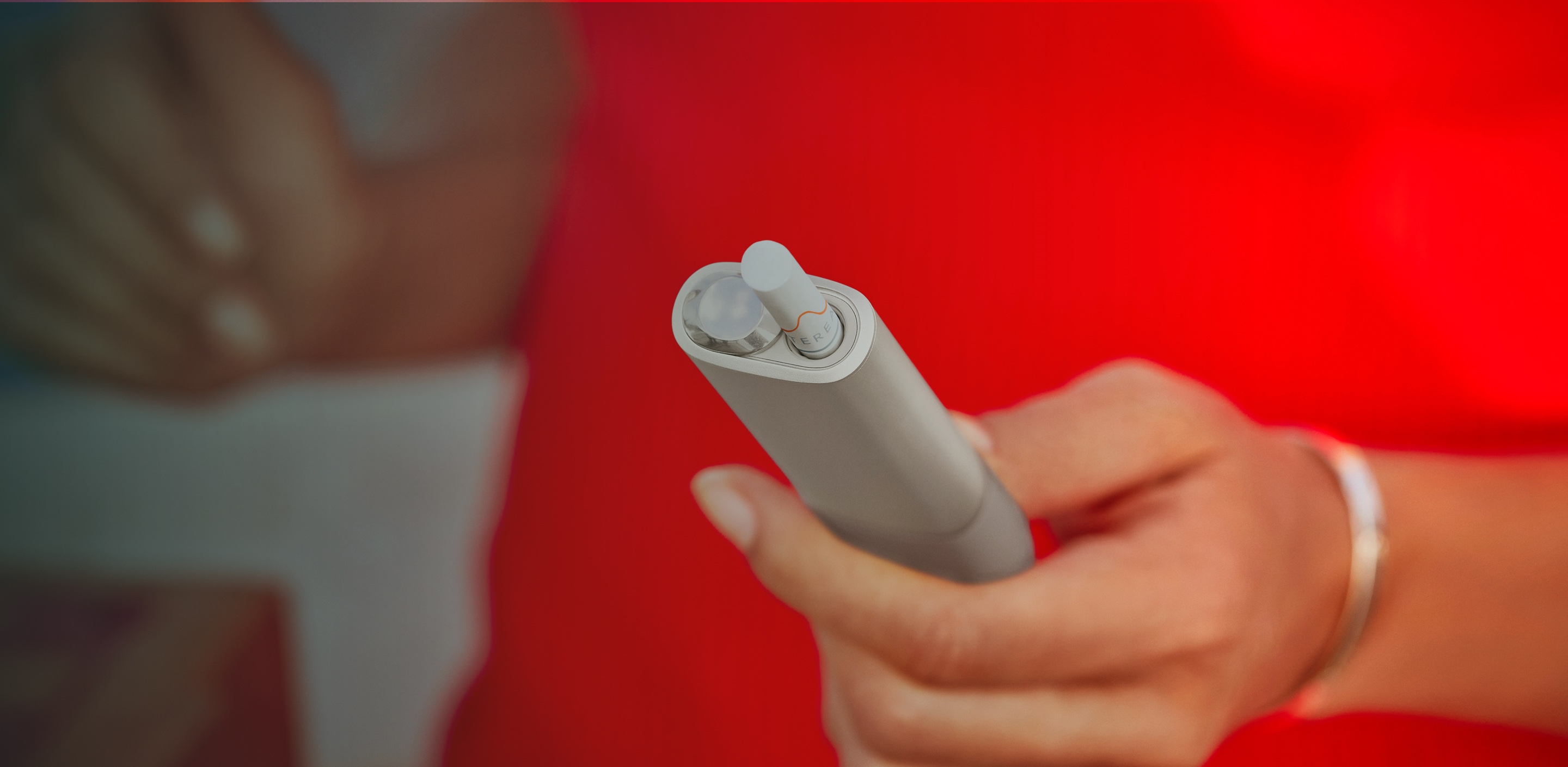 Zariadenie IQOS ILUMA ONE v ženskej ruke