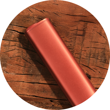 IQOS ILUMA i ONE Device with TEREA Pack on wooden table