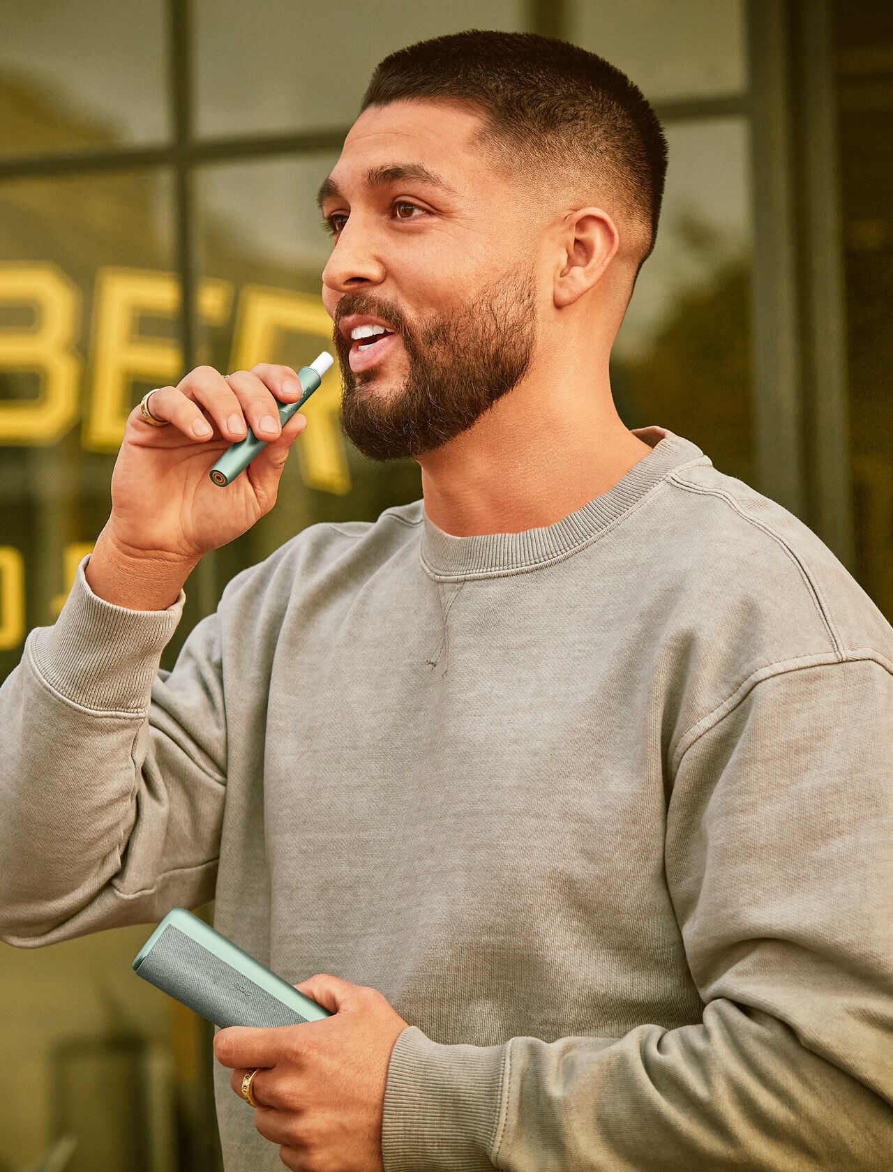 A man holding an IQOS device.