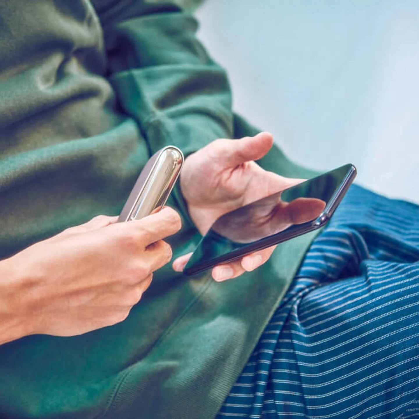 Person registering their IQOS device online by smartphone