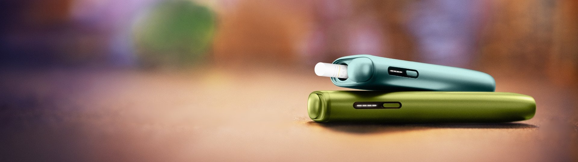 Two IQOS Iluma I One devices on a background of a table