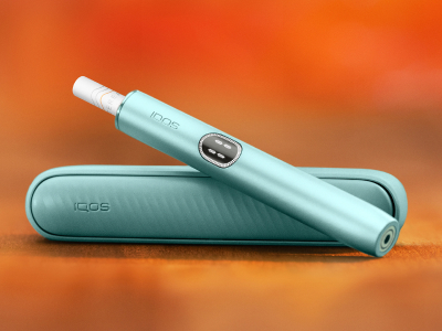 Breeze Blue IQOS Iluma i Holder and charger on a brown table background
