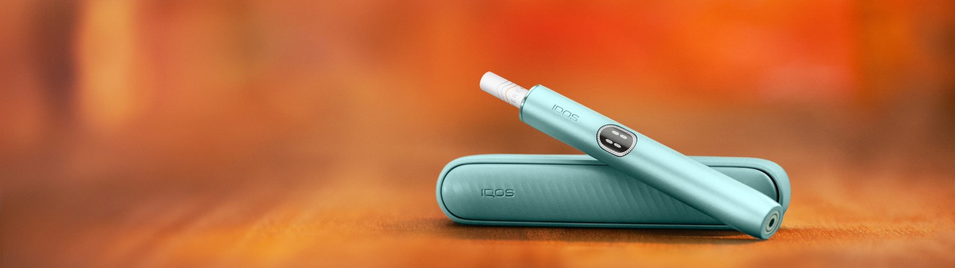 Blue Breeze IQOS Iluma I Mid Devices and Charger on a desk