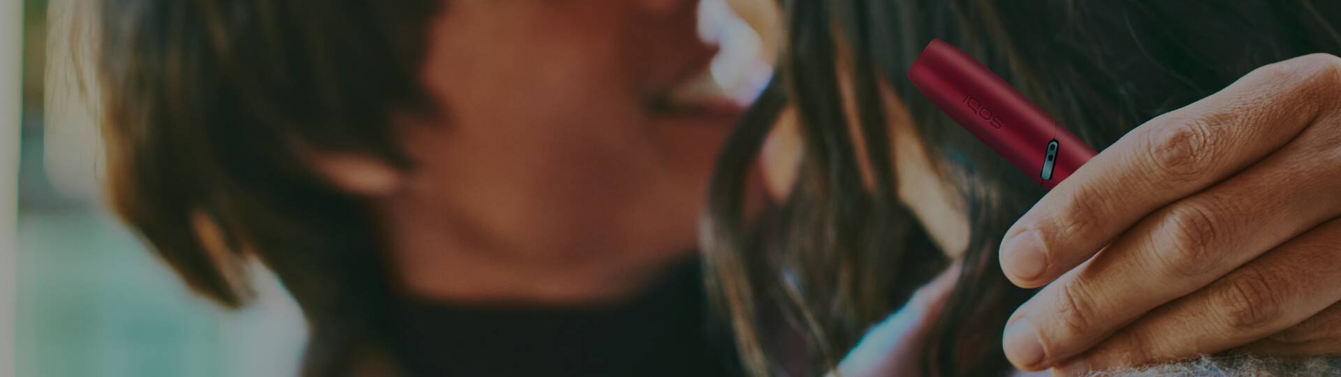 Young man opens his IQOS gift box