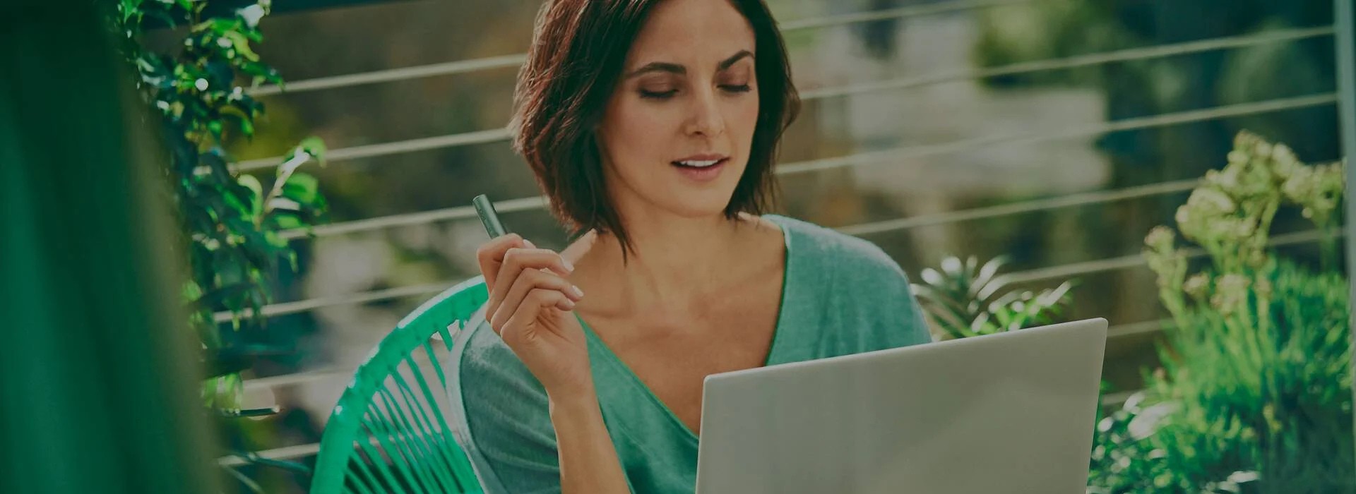 An IQOS ILUMA Pocket Charger and Holder on a laptop.