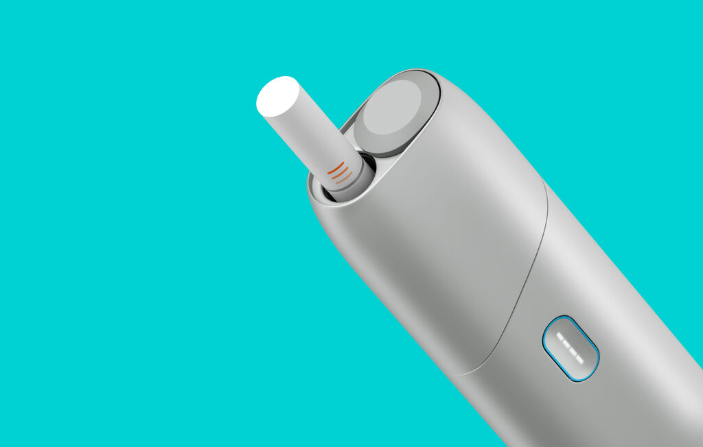 Silver IQOS Originals ONE heated tobacco device with HEETS stick.