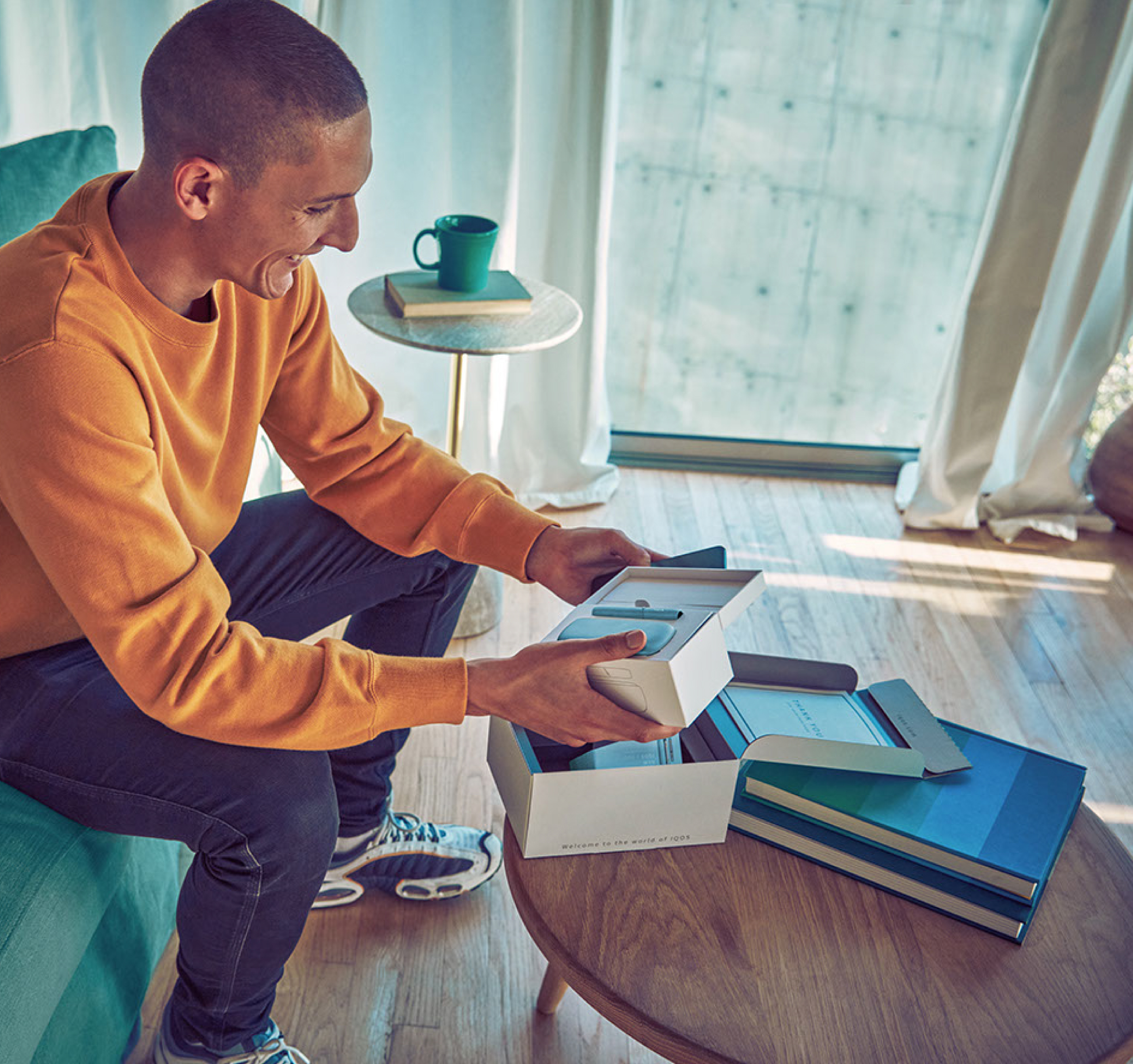 A smiling man holdiing an IQOS device. A smiling man holdiing an IQOS device.