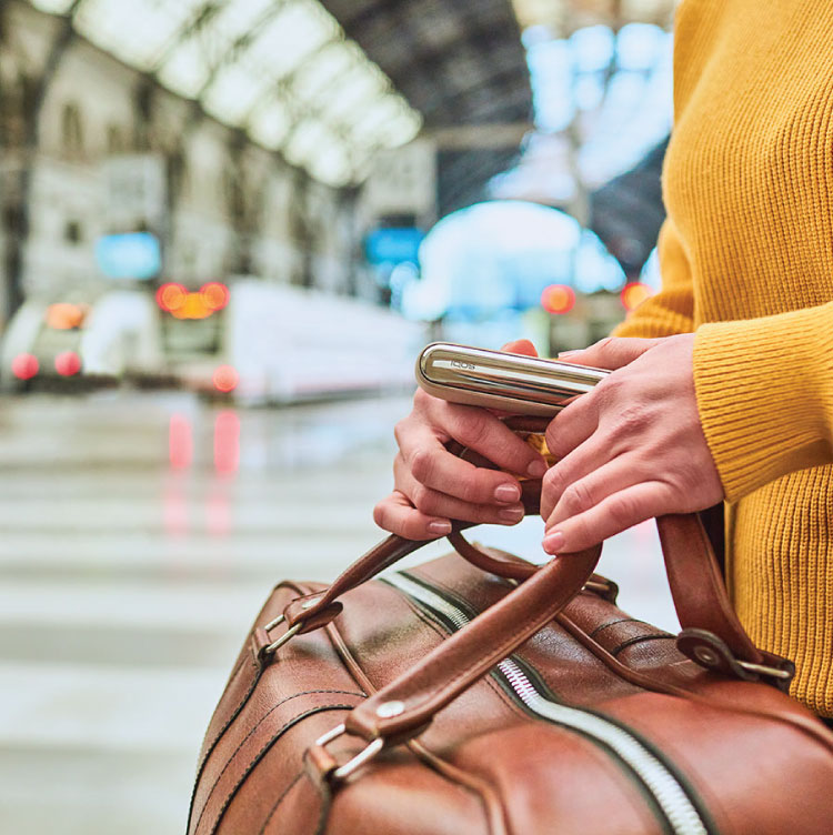 Travel documents, a mobile phone and an IQOS ILUMA PRIME Holder and Pocket Charger on a table. Travel documents, a mobile phone and an IQOS ILUMA PRIME Holder and Pocket Charger on a table.