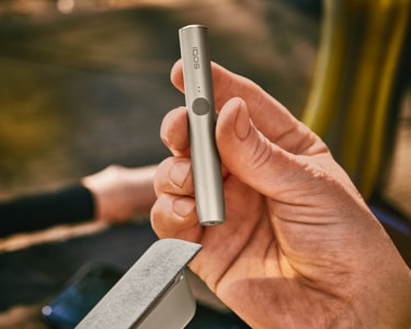 A pebble gray IQOS ILUMA device.