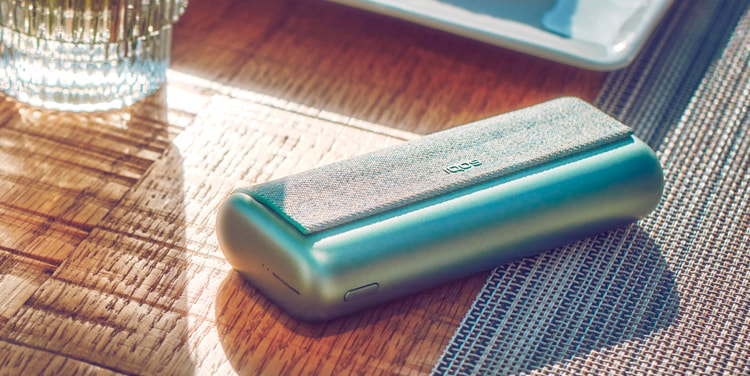 A Jade Green IQOS ILUMA PRIME Pocket Charger.