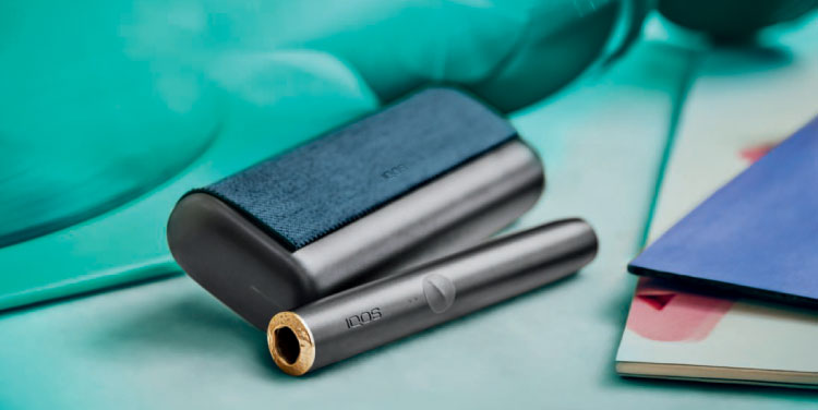 A person places a TEREA stick into an IQOS ILUMA PRIME Holder. A person places a TEREA stick into an IQOS ILUMA PRIME Holder.