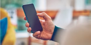 A person holding a mobile phone.