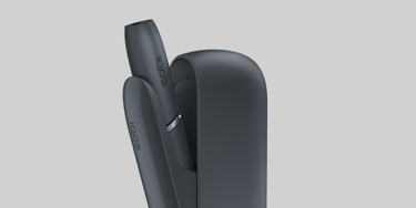 A mobile and a gold IQOS kit on a table