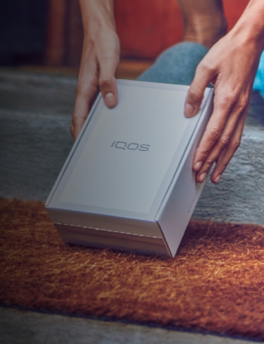 A person holding an IQOS box. 