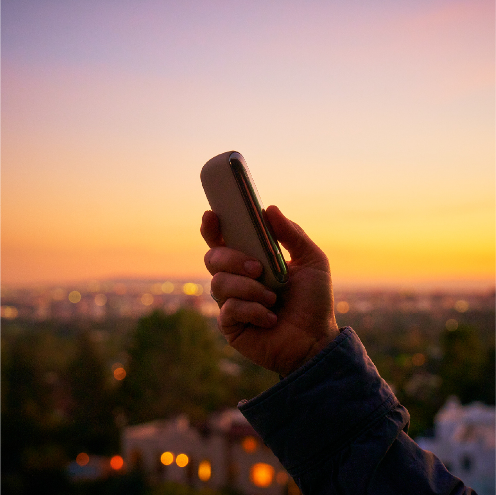 A person holding an IQOS device